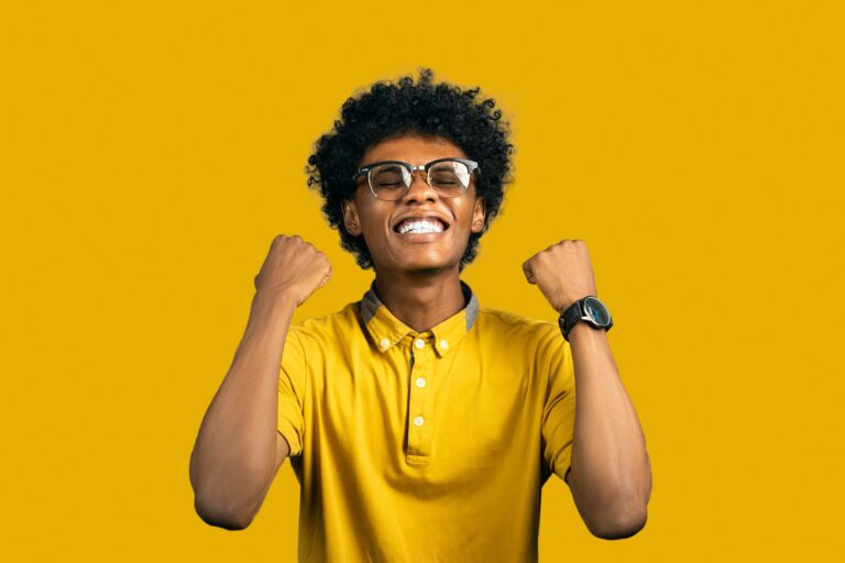 An excited person holding both fists in the air